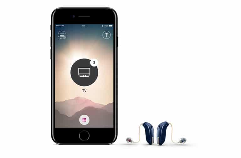 Hearing aids next to a smartphone