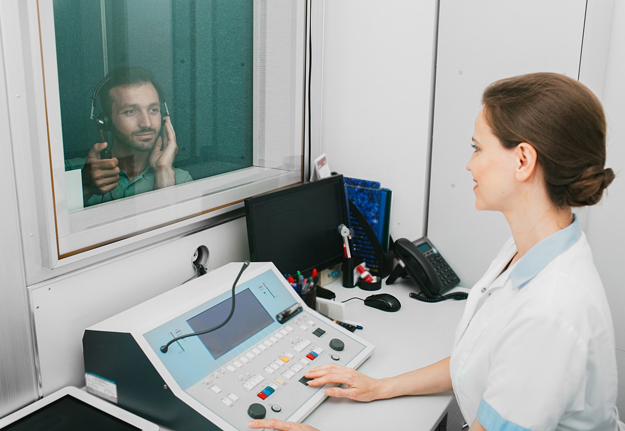 Hearing specialist conducts hearing test