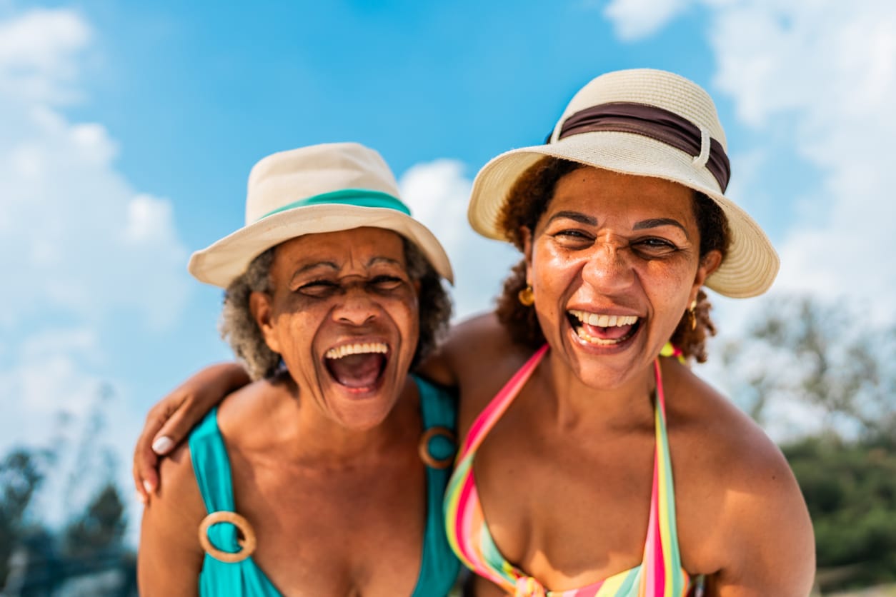 Happy smiling women with sun hats.