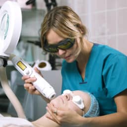 Woman undergoing laser skin treatment