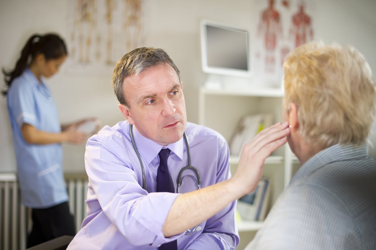 Provider examining a woman's ear.