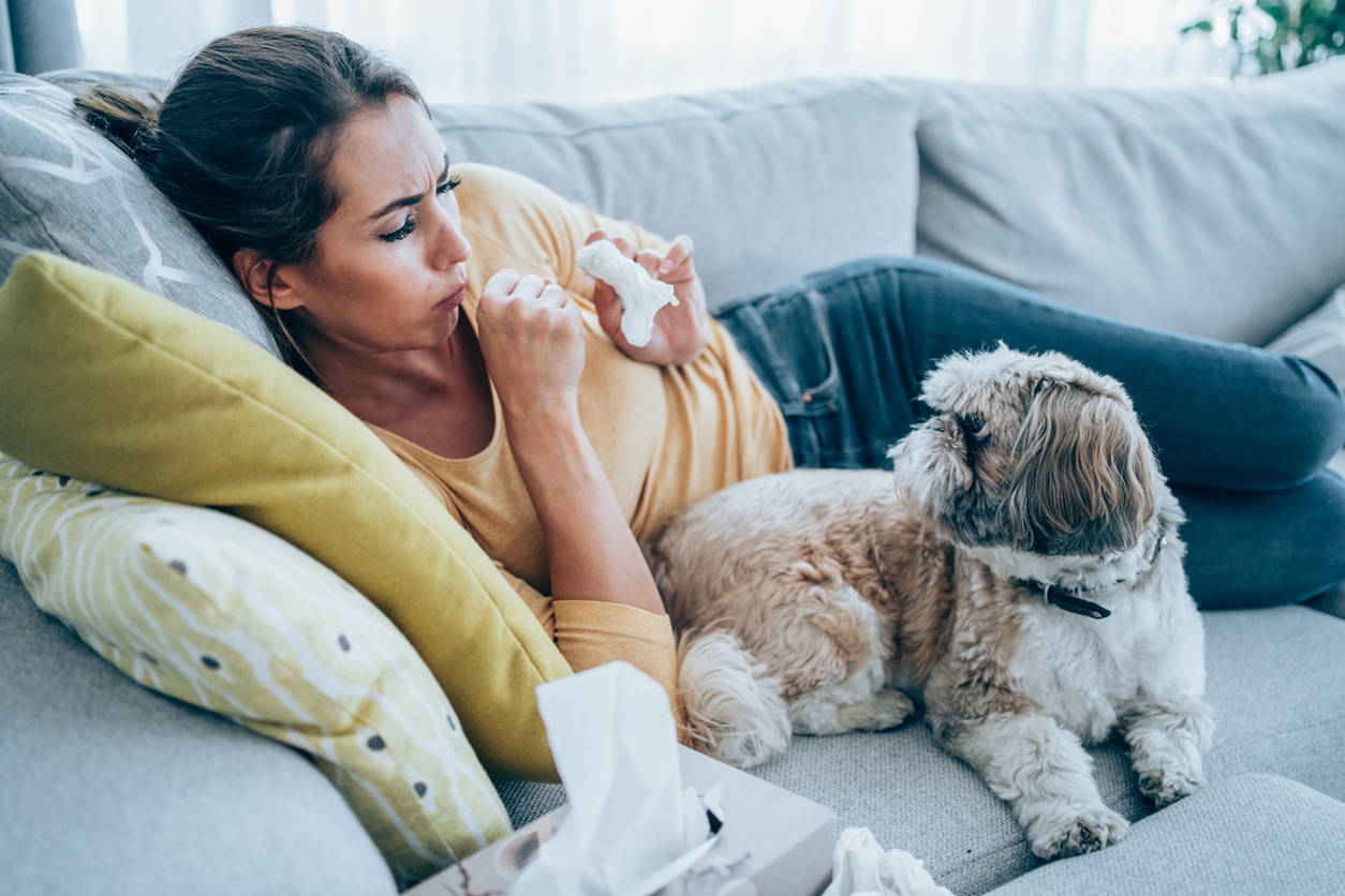 Woman with pet allergies sitting with her dog.