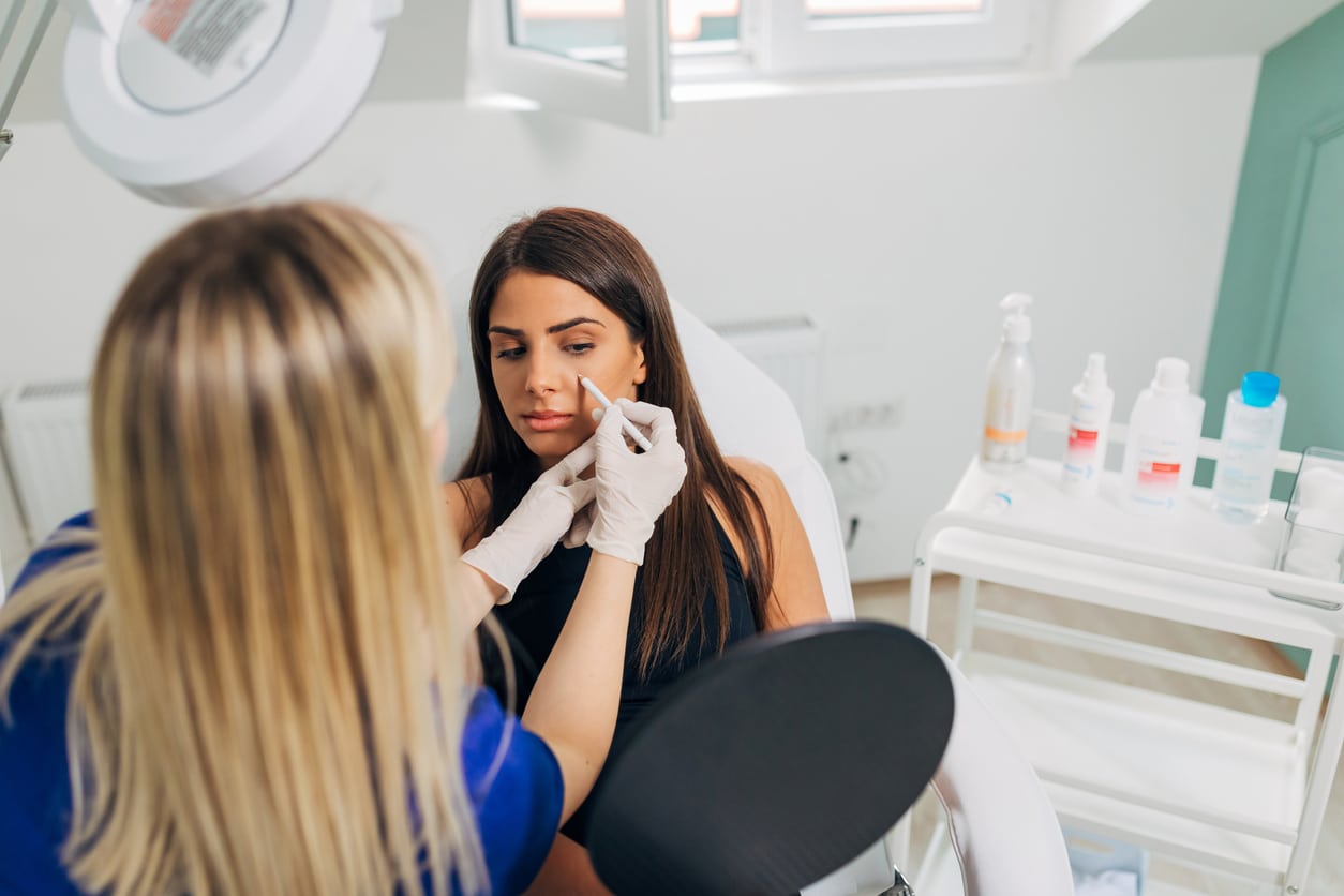 Woman doing a rhinoplasty consultation. 