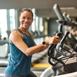 happy woman on a treadmill at the gym