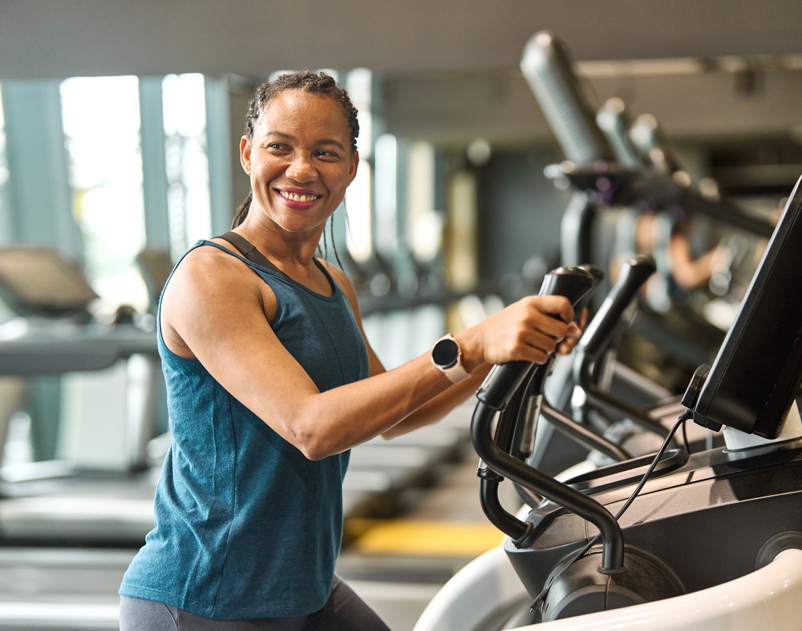 happy woman on a treadmill at the gym.