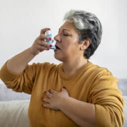 Senior woman using an inhaler